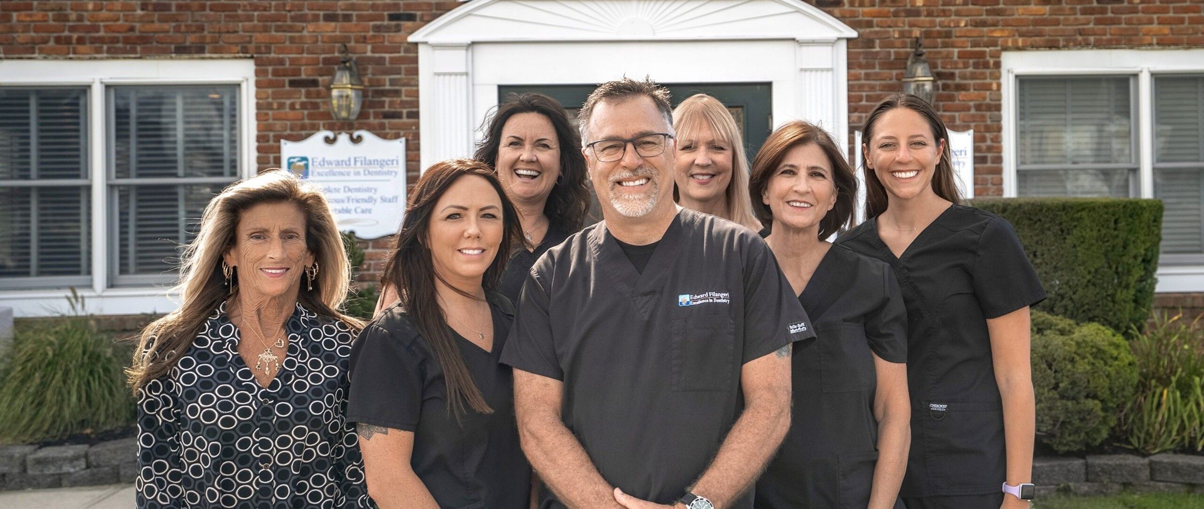 Dr. Ed Filangeri and his team in front of the office